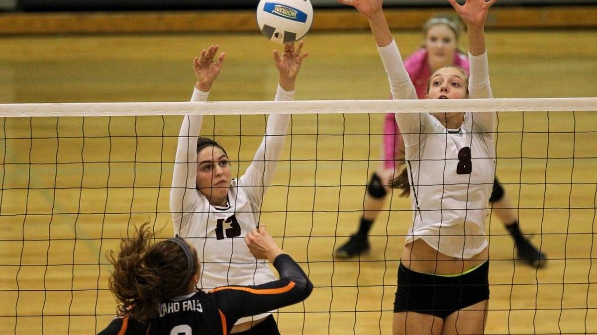 Centennial’s Savannah Ipsen (13) and Allison O’Harra (8) blocks a shot by Idaho Fall’s Maya Taylor (8) during the opening round of the 5A state volleyball tournament at Post Falls High.