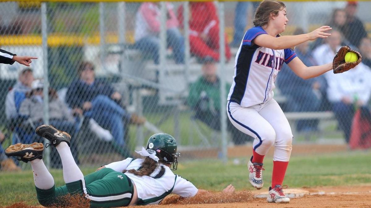 Eagle’s Autumn Moffat dives back to the base as Coeur d’Alene third baseman Mariah Montee tries to tag her out during the second game of the 5A state tournament on Friday at Bonneville High in Idaho Falls.