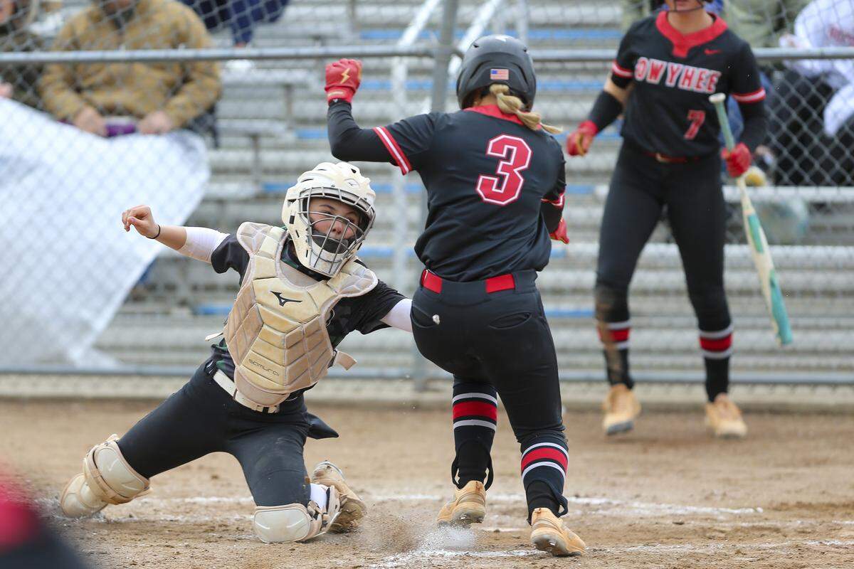 Eagle catcher Polly McAllister stops Owyhee’s Avery Hessing from scoring in the championship round of the 6A softball state tournament Saturday at Coeur d’Alene High.