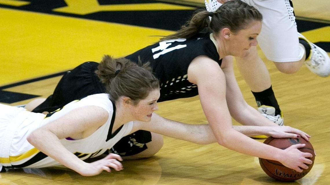 Bishop Kelly player Alison Eddy (left, 5) and Kuna player Allison Law (top, 41) dive for a loose ball during a 4A Southern Idaho Conference game at Bishop Kelly High on Jan. 15, 2016.