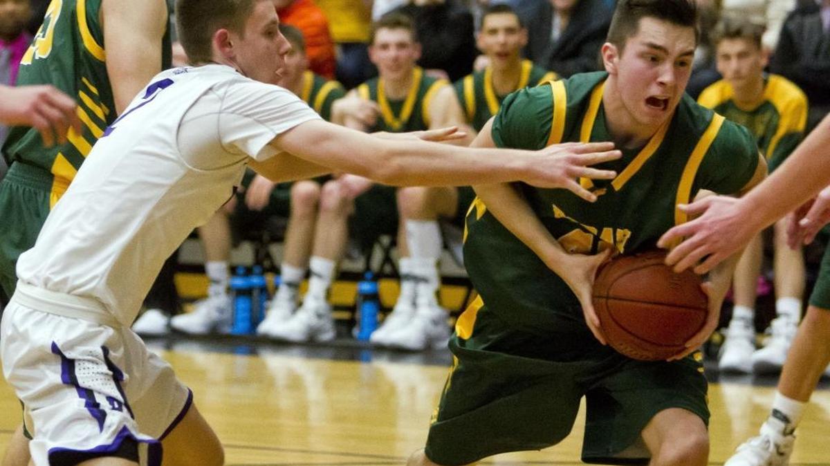 Borah forward Derek Opland-Evers keeps control of the ball in the key despite pressure from Rocky Mountain’s Tyler O’Donnell on Saturday at Rocky Mountain High.