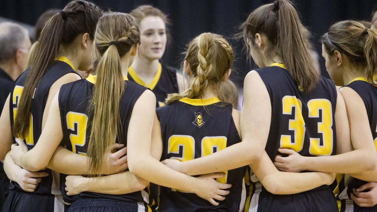 The Bishop Kelly girls basketball team gathers just before tip-off of the 4A state championship against Century on Saturday at the Ford Idaho Center.
