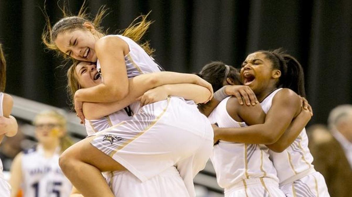 Middleton High School players (from middle, left to right) Rilee Moser (23), Lexi Mitchell (5), Meriah Deugan (1) and Daycee Deugan (10) embrace at the end of the in the 4A girls basketball state championship game against Bishop Kellyheld at The Ford Idaho Center in Tampa, Idaho. Middleton defeated Bishop Kelly 57-45. Saturday February, 18, 2017.