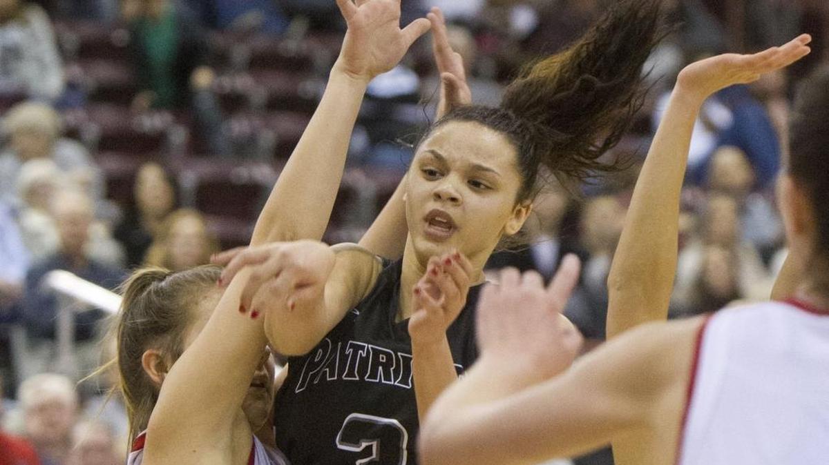 Centennial’s Tori Williams passes out of a Madison double team during Friday’s 5A girls basketball semifinal at the Ford Idaho Center in Nampa. Williams scored 22 points in the Patriots’ 50-35 victory.