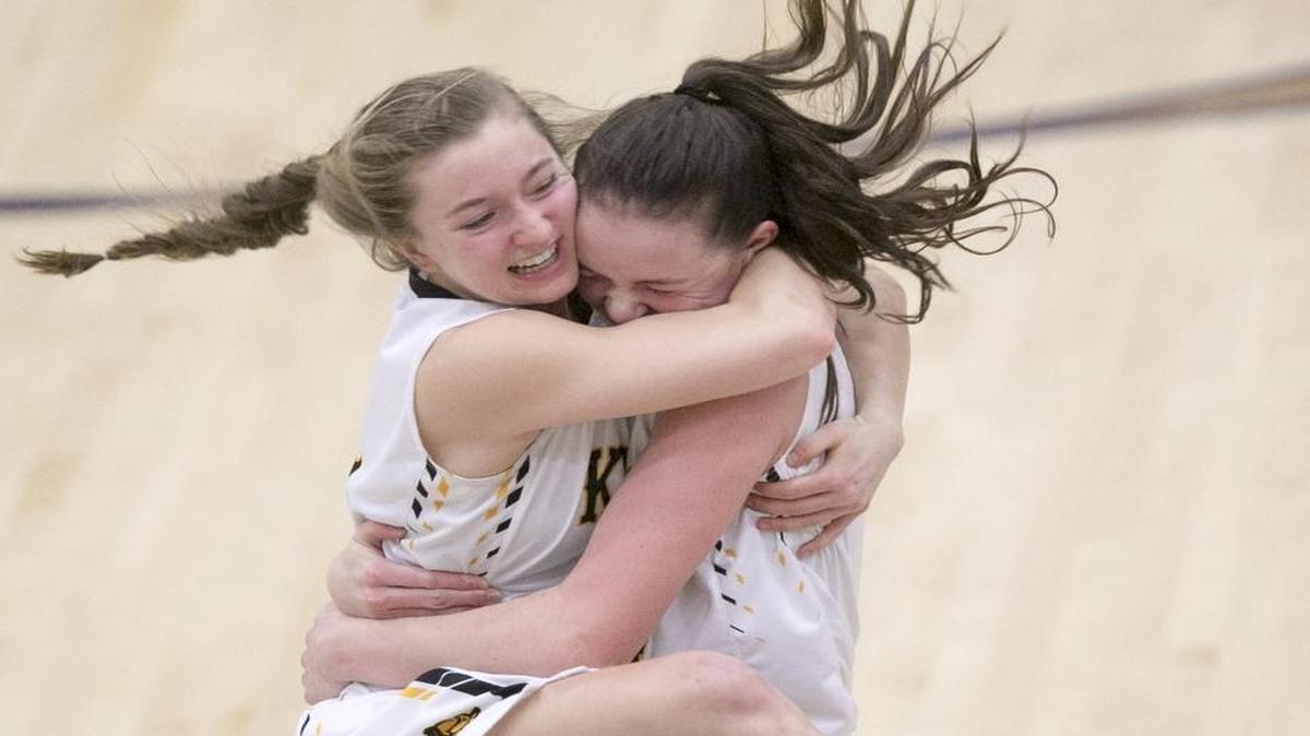 Bishop Kelly’s Lydia Nieto, right, and Lily Shalz celebrate after the final buzzer of their 33-30 overtime win against Twin Falls in the 4A state semifinals at Mountain View High.