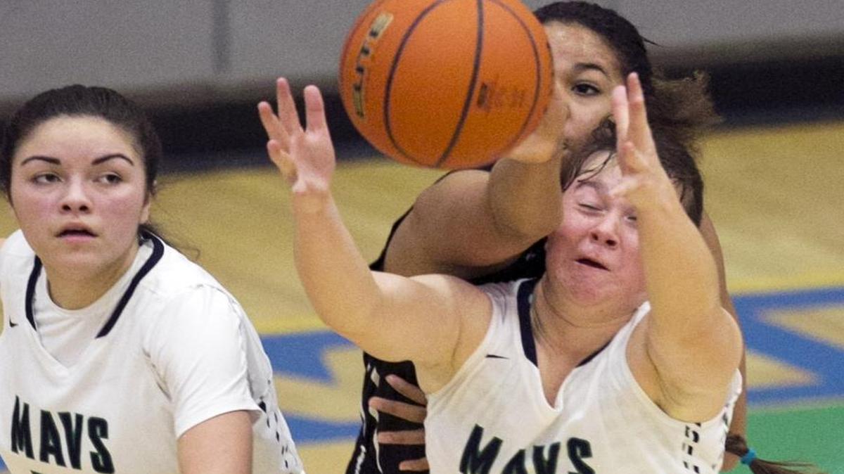 Mountain View High School girls basketball player Abby Kreiser (front, 12) collects a loose ball while being fouled by Centennial High School player Asha Tullock (back, 12) during the first half of a game Tuesday, Jan. 5, 2016, at Mountain View High in Meridian. Mountain View defeated Centennial 64-59. Mountain View player Devene Villarreal (left, 22) is also pictured.