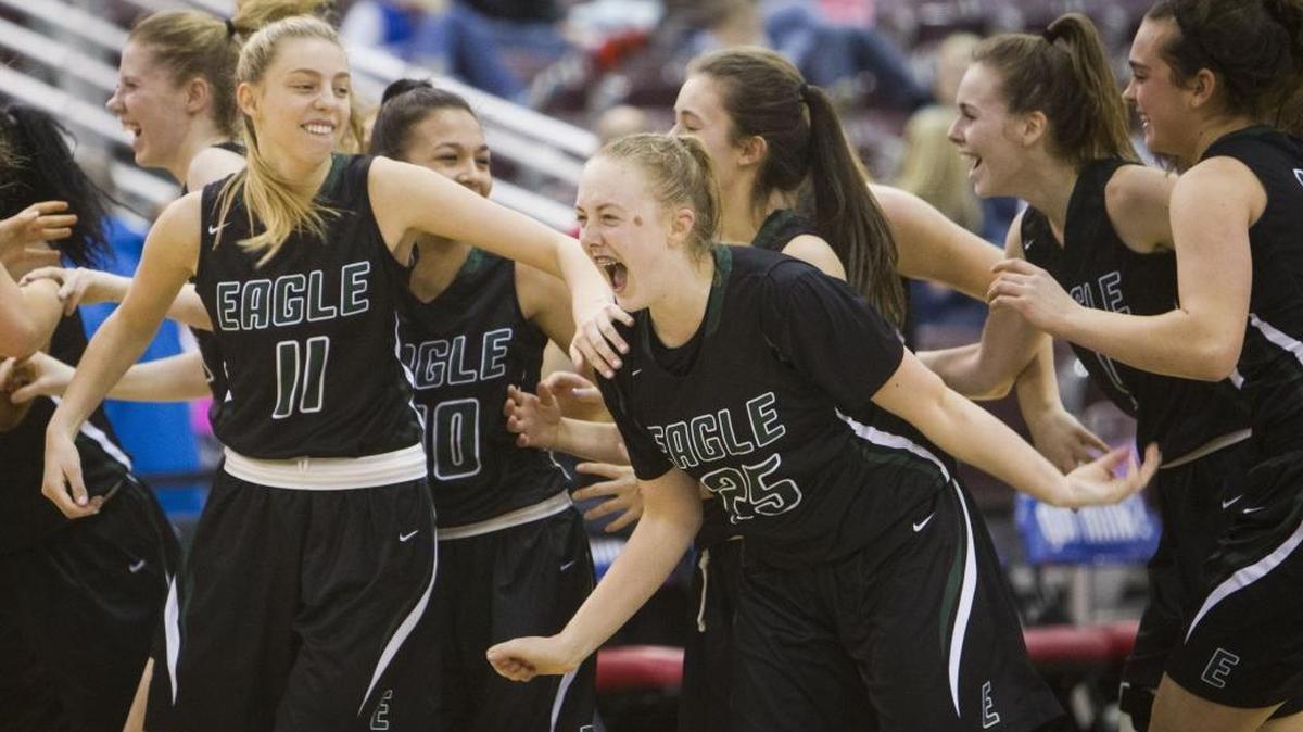Meghan Boyd, right, and Janie King celebrate Eagle’s 57-54 victory over Post Falls in the 5A state semifinals last year at the Ford Idaho Center in Nampa.