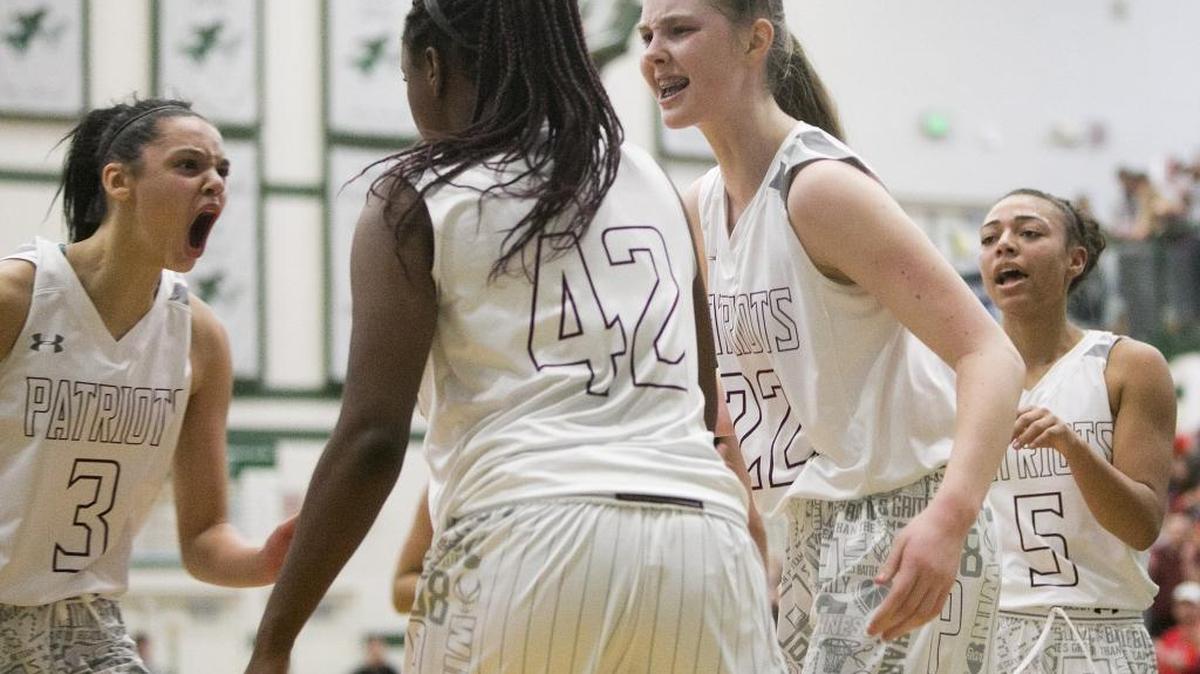 Centennial’s Tori Williams (left, 3) Lauren Brocke (middle, 22) and Ayana Amaechi (right, 5) celebrate with teammate Dominique Williams (42) after she scored a basket and was fouled during the 5A District Three Tournament girls basketball semifinals Saturday at Eagle High.