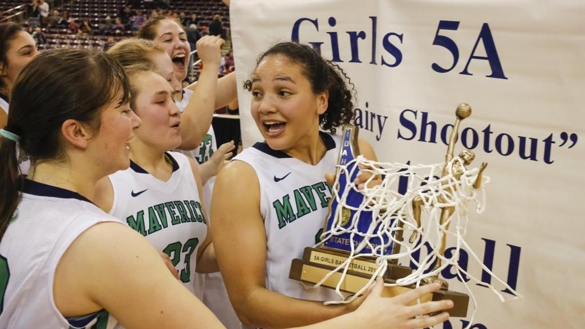 Mountain View’s Destiny Slocum holds the trophy after the Mavericks won the 5A state championship Feb. 21 at the Idaho Center in Nampa.