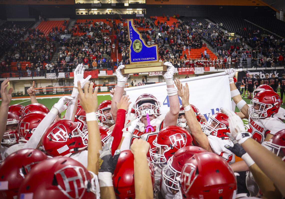 The Homedale football team hoists the 4A state championship trophy after a 29-21 victory over Kimberly at the ICCU Dome in Pocatello. 