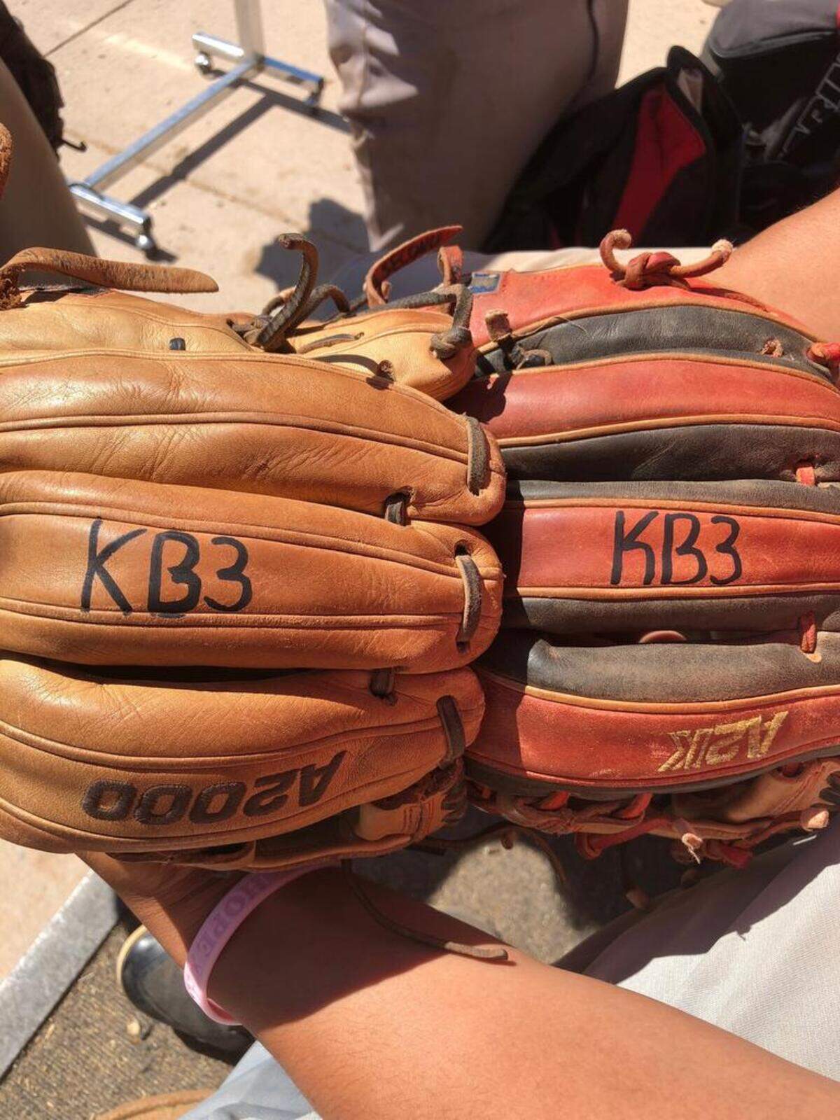 Payette baseball players have inscribed Kodee Bennett's initials and number onto their gloves.