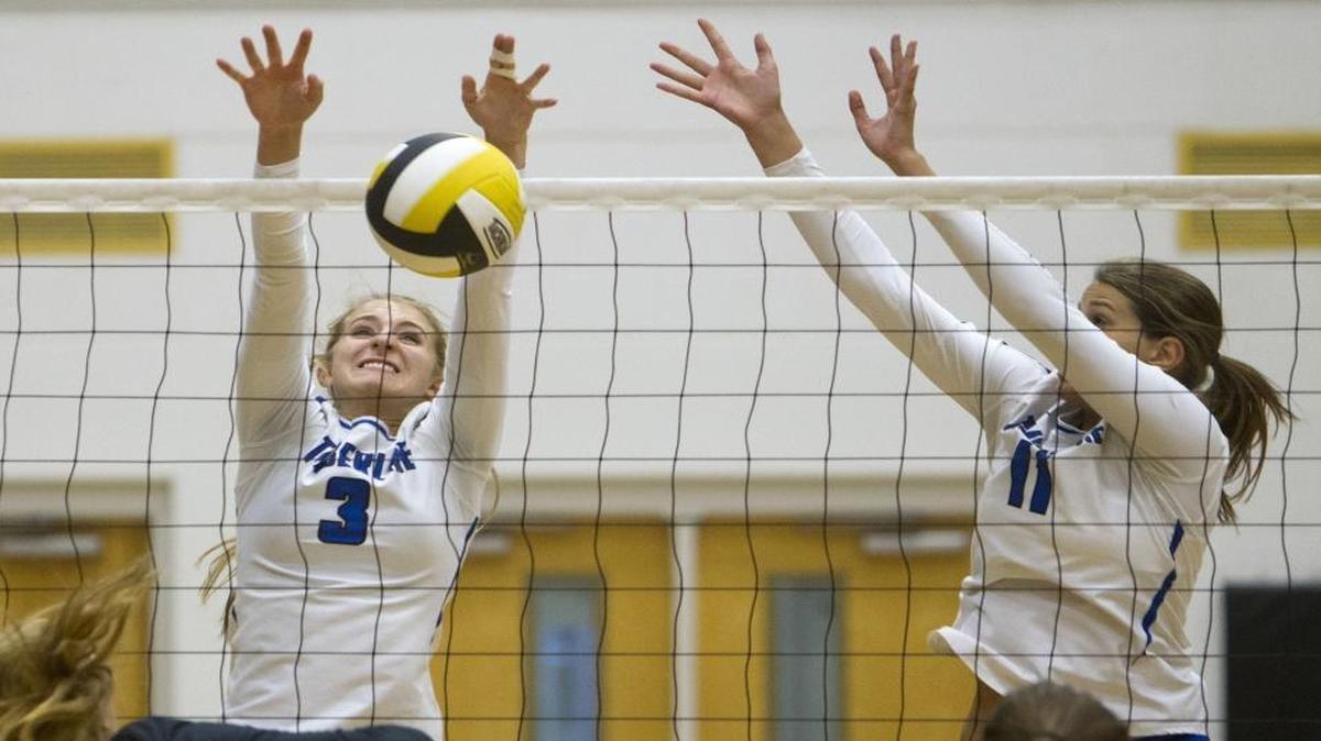 Junior middle/rightside Bridget Ward, left, and junior middle Lily Johnson put up a block for Timberline in a sweep of Capital last week. The Wolves were chosen as the favorites in a 5A Southern Idaho Conference coaches’ poll, receiving seven first-place votes.