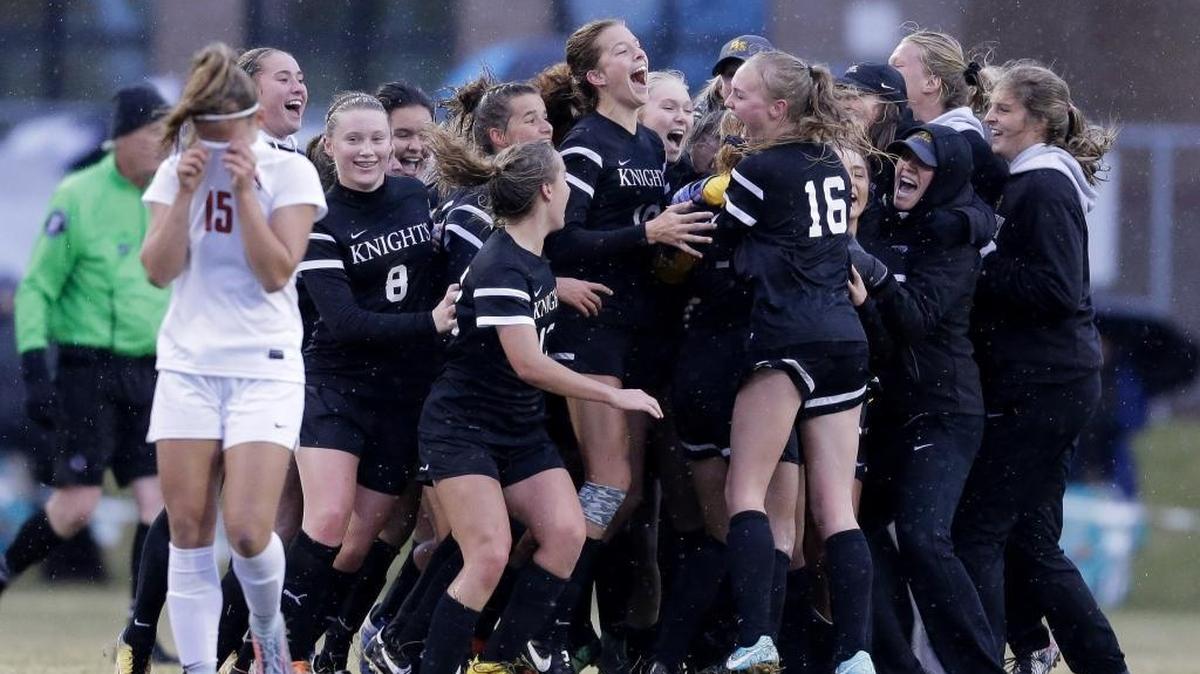 Bishop Kelly celebrates its second straight state titles last season at Middleton High. The Knights have won 61 straight games and are gunning for their third consecutive championships.