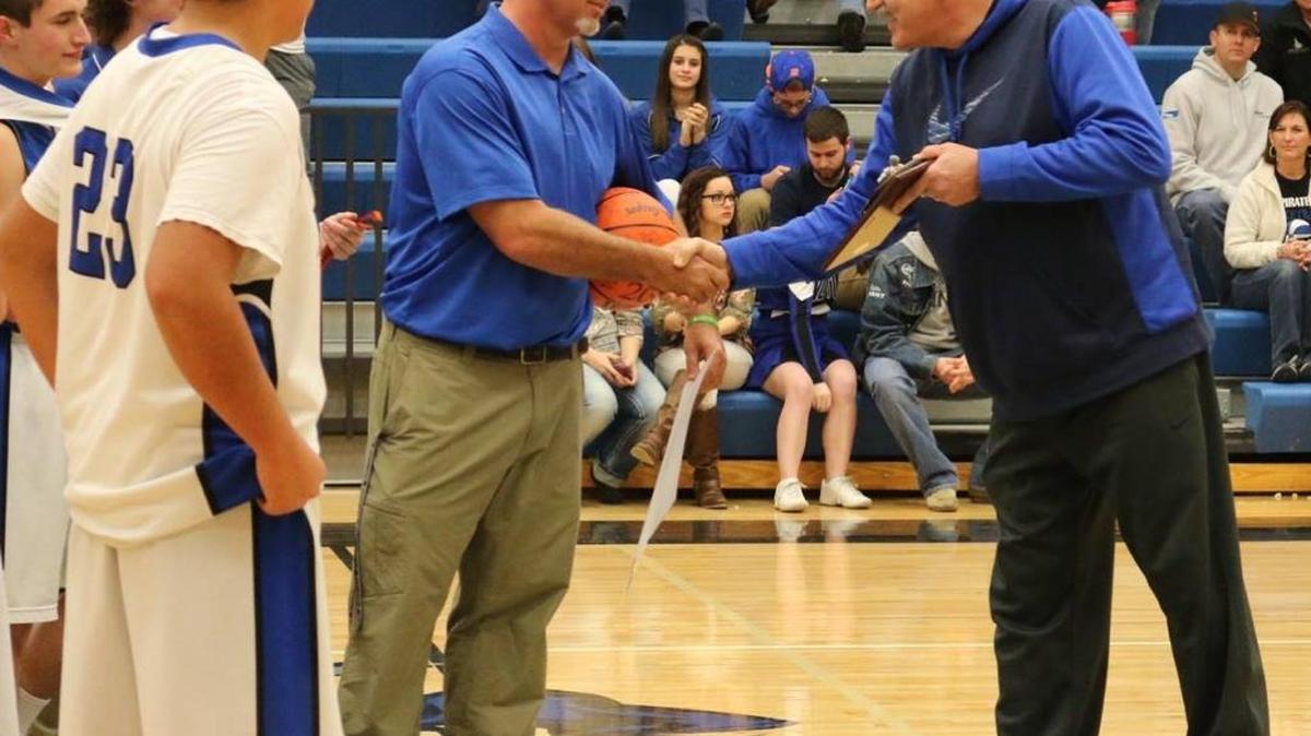 Notus Athletic Director Tim Dranginis, right, congratulates Pirates boys basketball coach Jon Conner on his 200th victory on Feb. 5 at Notus High.