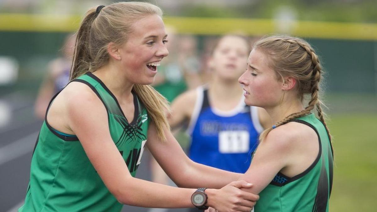 After finishing first in the girls 1,600 meters, Mountain View freshman Lexy Halladay, left, congratulates teammate Kortlyn Lowry on her state-qualifying run in the same race at the 5A District Three track and field meet.