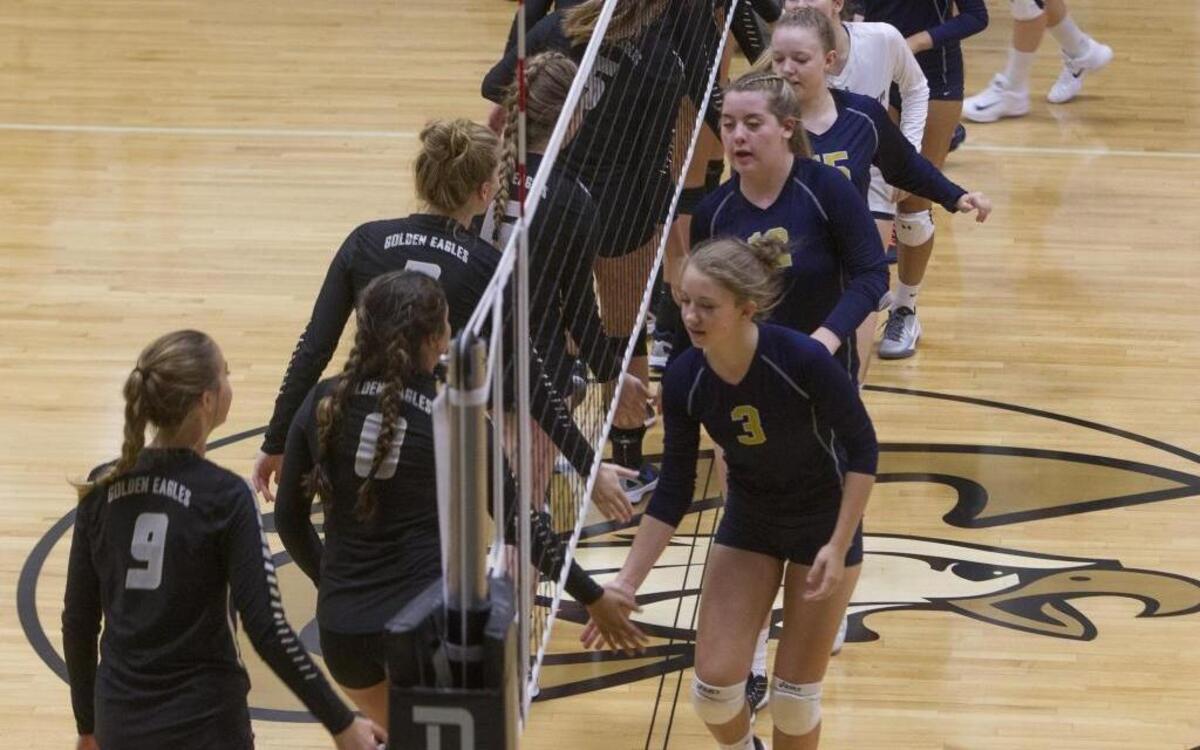 The Capital, left, and Meridian high school volleyball teams greet each other before the start of their Sept. 7 match at Capital. Players at Meridian and in the West Ada School District must pay $110 to play, while Capital and the Boise School District doesn’t charge any pay-to-play fees.