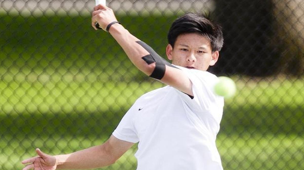 Eagle’s Adam Tzeng hits a return during his 6-1, 6-0 championship win against Mountain View’s Lucas Dibelius in boys singles at the 5A District Three Tournament on May 13 at Julia Davis Park in Boise. Tzeng also plays violin in the school’s orchestra.