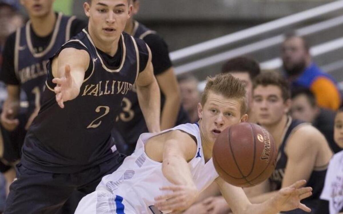 Preston guard Kaleb Fenton gets a pass off the baseline while guarded by Vallivue’s Jerred Monnier in 4A boys basketball state championship at the Ford Idaho Center.