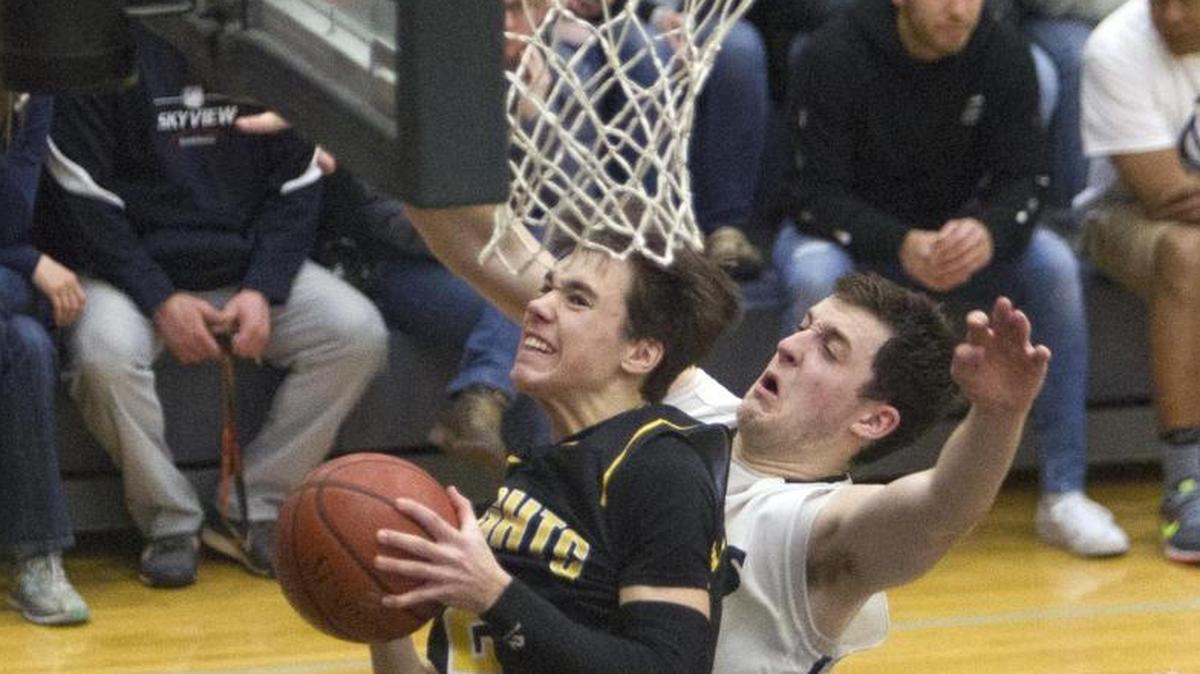 Bishop Kelly guard Henry Hunter scores while being fouled by Skyview’s Jayson Hibbard during the 4A District Three championship game Saturday.