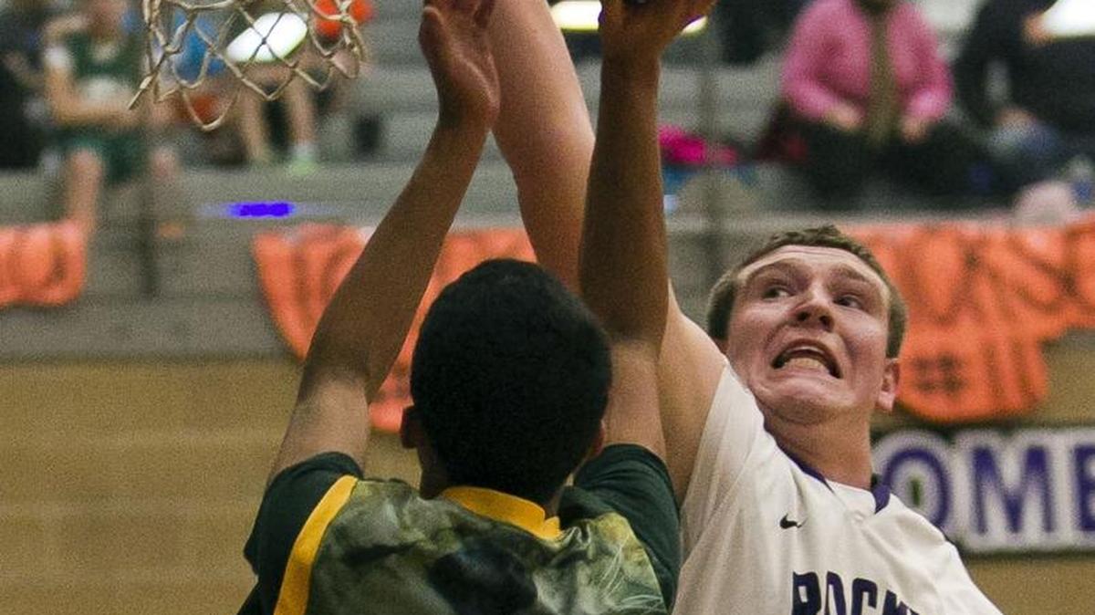 Rocky Mountain center Kolby Lee blocks the shot of Borah’s DeAndre Jones on Jan. 31 at Rocky Mountain. Both Lee and Jones lead loaded teams into the 2015-16 season.