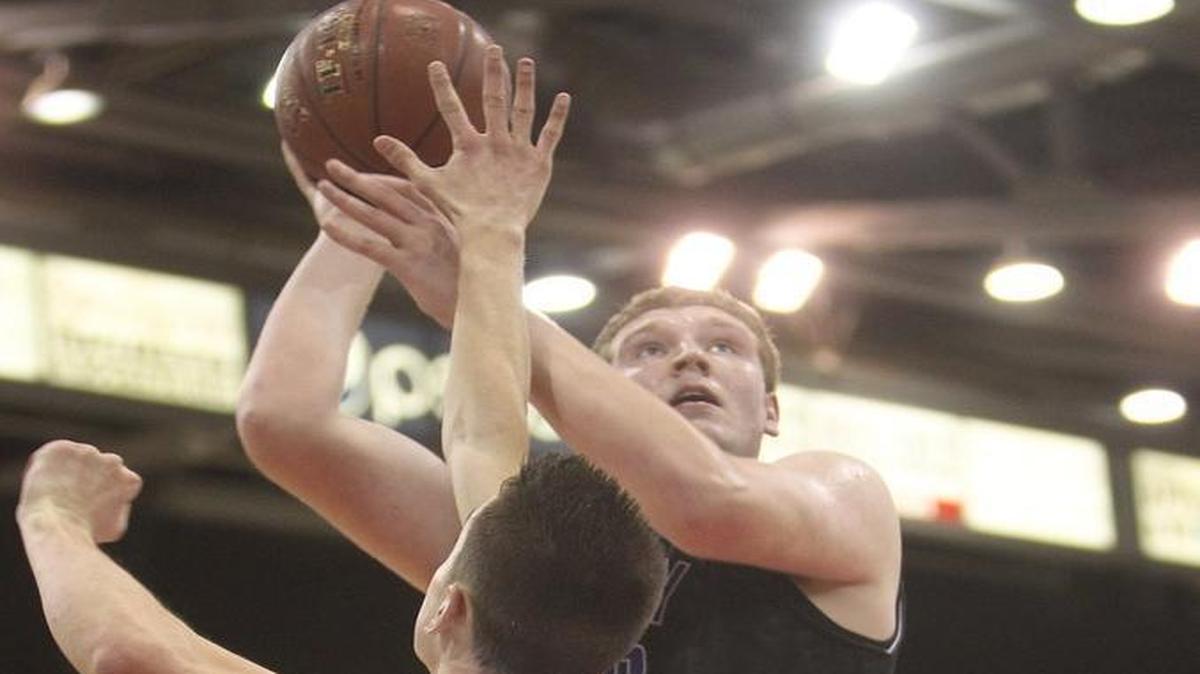 Rocky Mountain’s Kolby Lee rises over a Madison defender during the first round of the 5A state tournament last year at the Ford Idaho Center in Nampa.