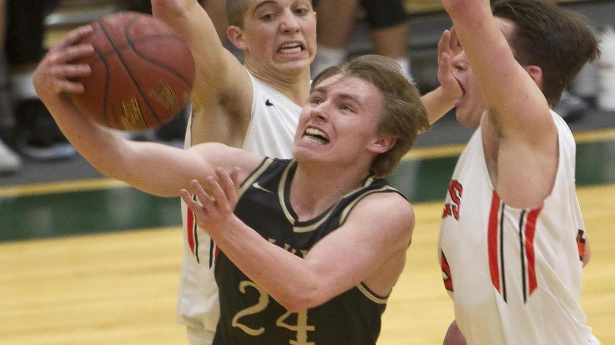 Vallivue guard Nick Fitts drives past Idaho Falls defenders Austin Staker, left, and Cooper Peterson in the semifinals of the 4A state tournament March 3 at Borah High.
