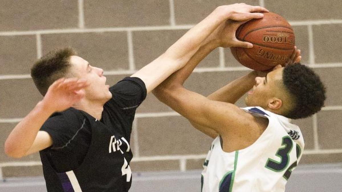 Rocky Mountain’s Tyler O’Donnell, left, blocks the shot of Mountain View’s Jalen Galloway on Jan. 27 at Mountain View High.