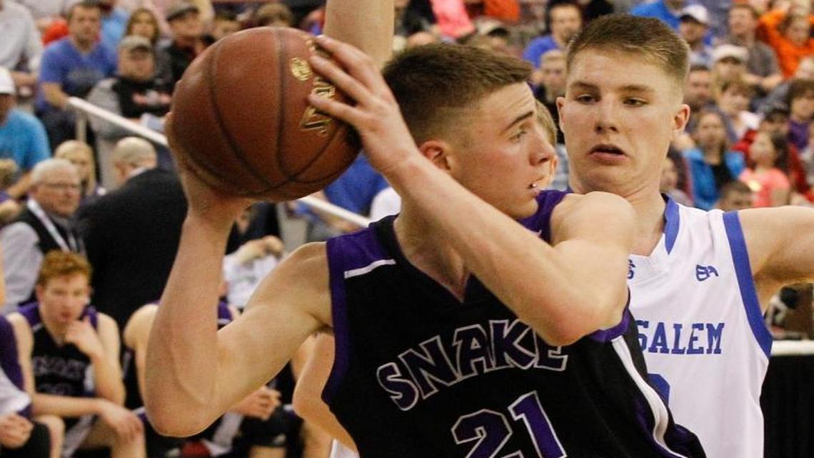 Snake River’s Clancy Thomas (21) keeps the ball away from Sugar-Salem’s Parker Miller during overtime in the 3A state championship game March 4 at the Ford Idaho Center in Nampa. Sugar-Salem won 71-69.