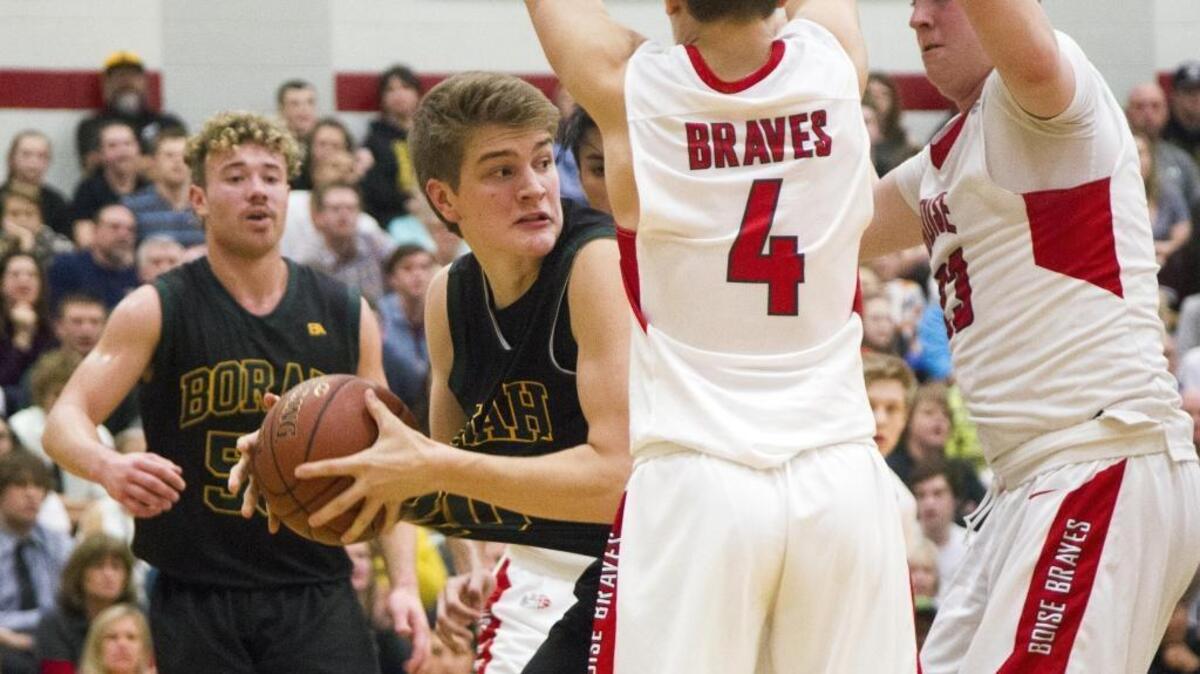 Borah’s Dillon Young looks for room to pass after an offensive rebound at Boise High on Jan. 20.