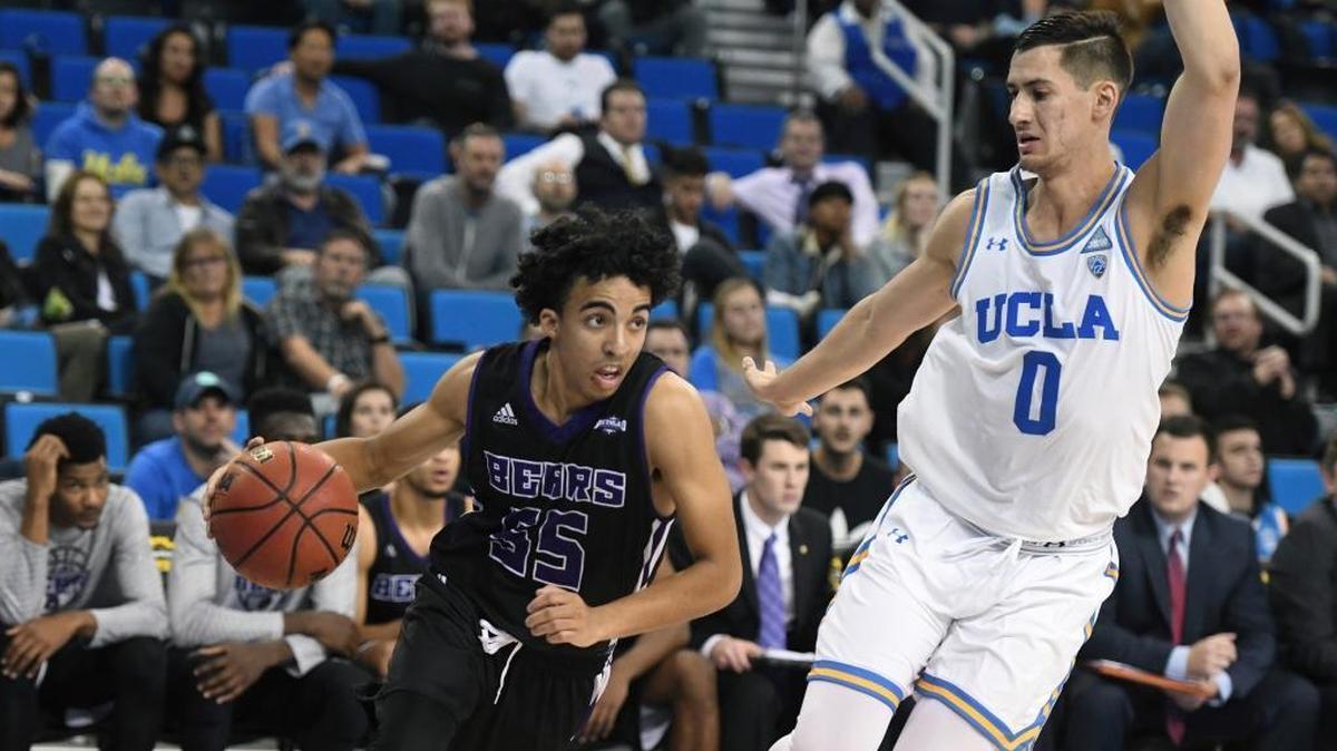 Borah grad and Central Arkansas guard DeAndre Jones, left, drives past UCLA’s Alex Olesinski on Nov. 15 in Los Angeles.