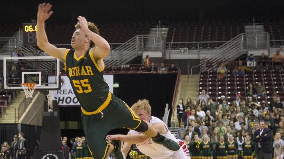 Borah senior point guard Ellis Magnuson leads the 5A SIC with 6.2 assists per game. Above, he draws a foul at last year’s state tournament.