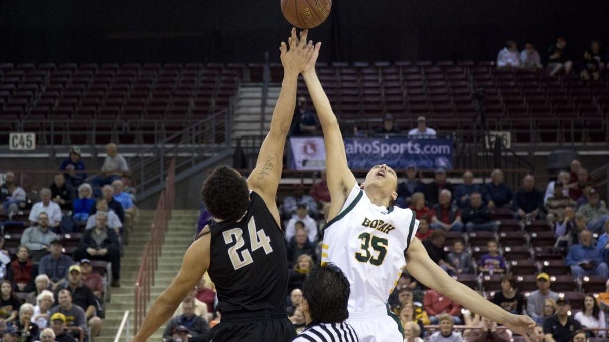 Borah’s Rylan Bergersen, right, and Capital’s Cameron Godeny-Scott jump for the tipoff in the first round of the 5A state tournament March 3 at the Ford Idaho Center in Nampa.