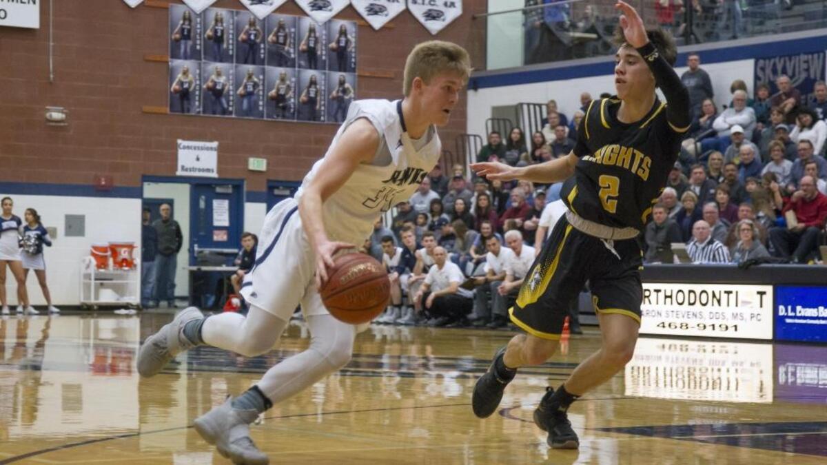 Skyview senior Taylor Thuernagle drives past Bishop Kelly’s Henry Hunter during the 4A District Three championship game Feb. 24 at Skyview High.
