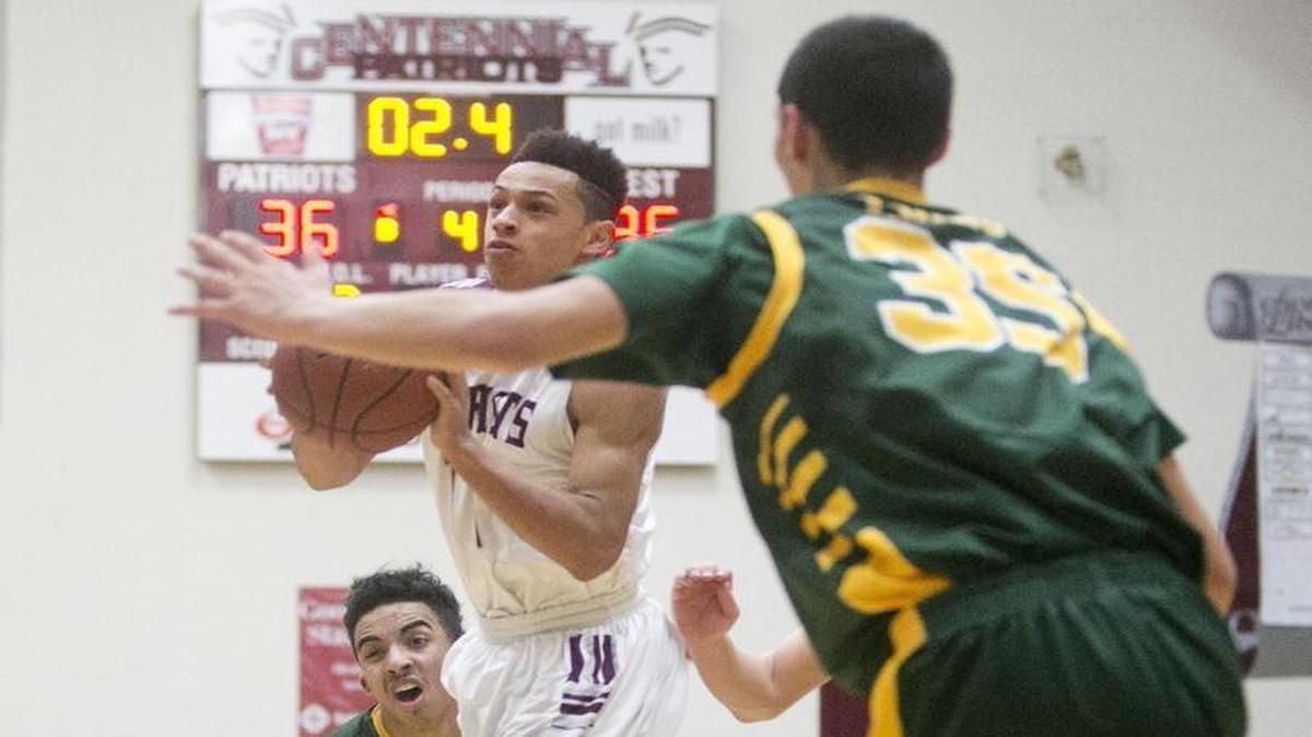 Centennial’s Talon Pickney, center, fires up a game winning shot with under 3 seconds to play against defense by Borah’s DeAndre Jones, left, and Rylan Bergensen during a Feb. 4 game at Centennial High.