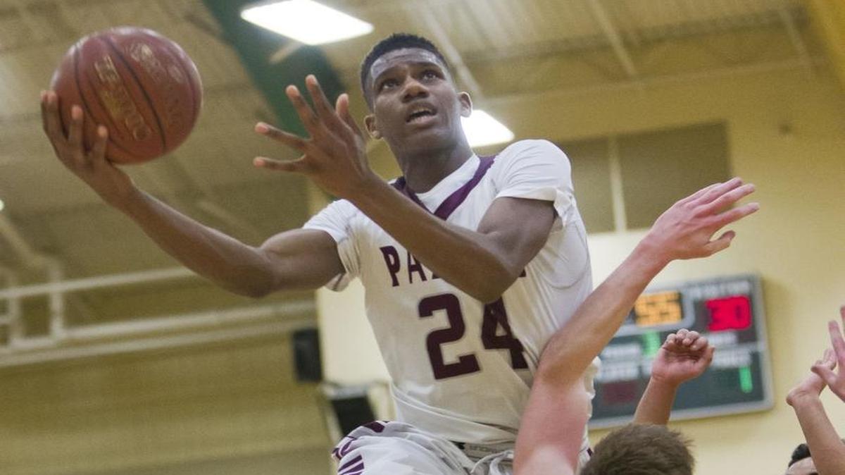 Centennial’s Delveion Jackson draws contact as he goes up for a layup in last year’s 5A District Three Tournament championship game at Borah.