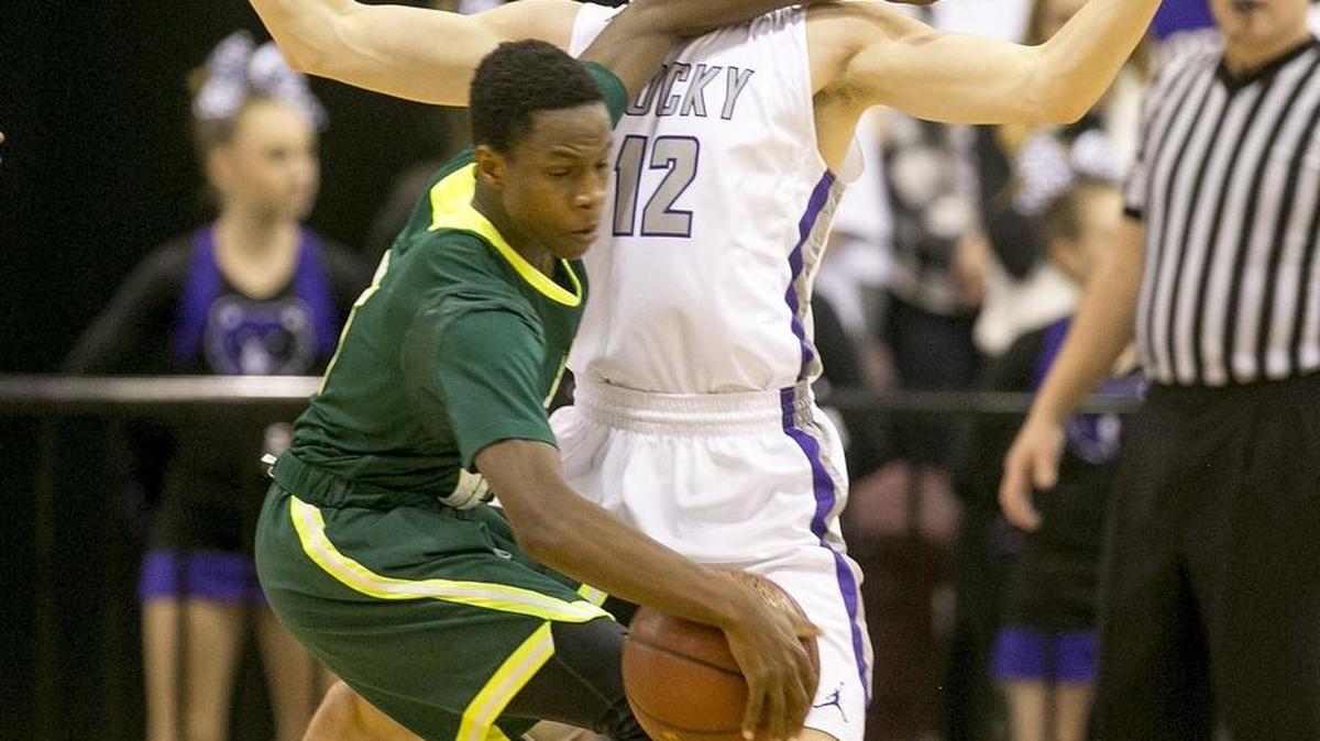Rocky Mountain’s Garrett Hall defends Bonneville’s Coleman Clayton, despite an elbow to the neck, during their 5A state tournament game Thursday at the Ford Idaho Center in Nampa. Rocky Mountain won 61-56.