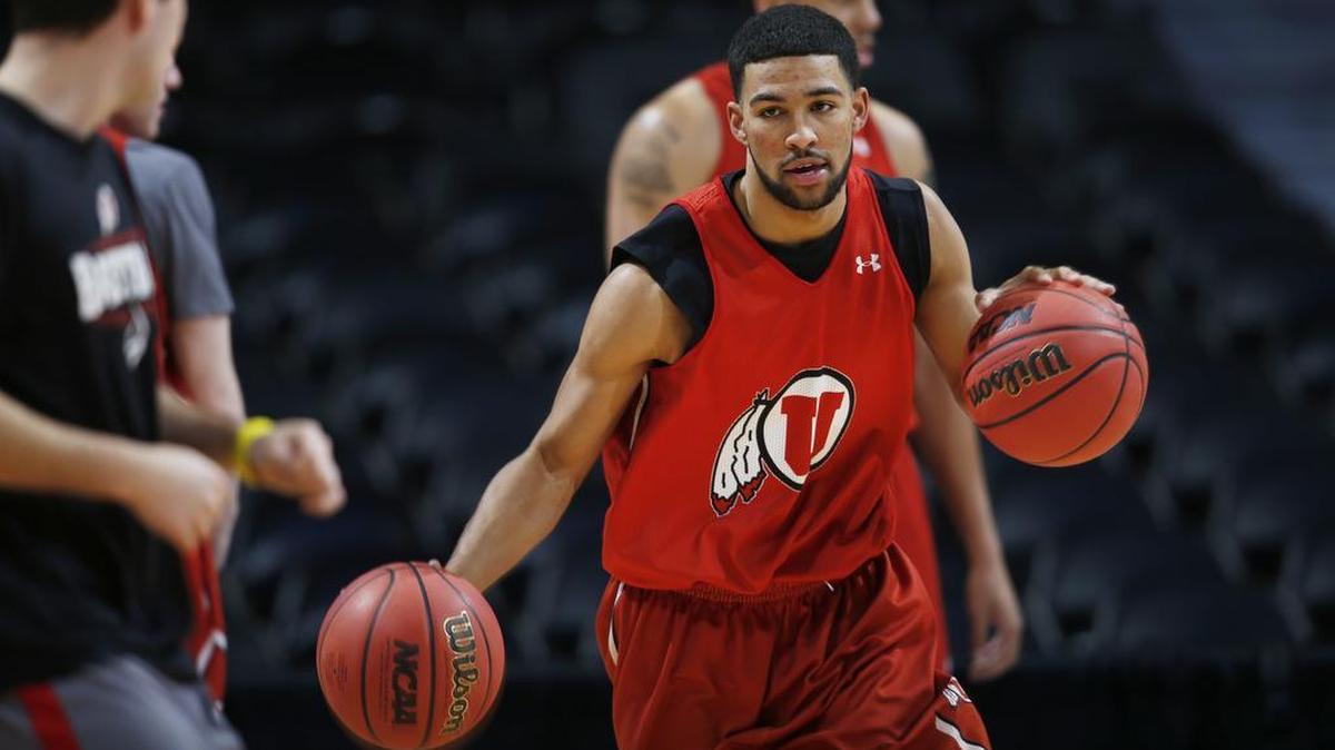 Utah guard Isaiah Wright, a Borah High graduate, dribbles two balls March 16 during a drill as the team practices for a first-round matchup in the NCAA tournament against Fresno State in Denver.