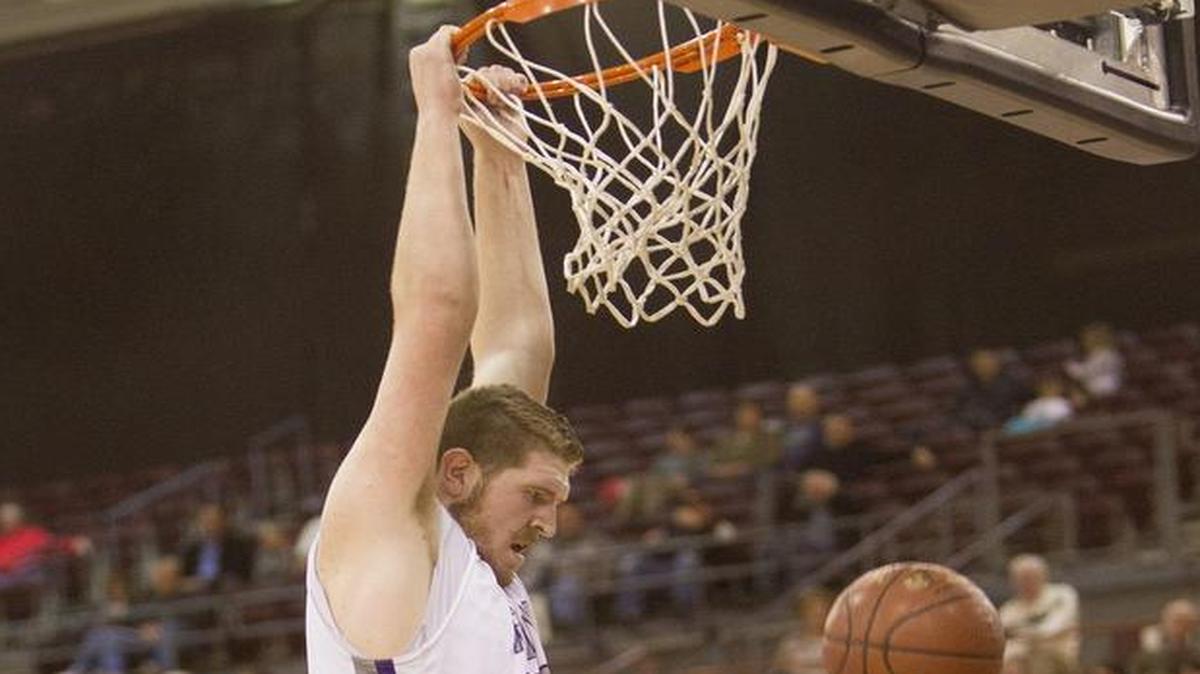 Rocky Mountain’s Kolby Lee dunks over Bonneville’s Kehari Harrigfeld during the first round of the 5A state tournament March 2 at the Ford Idaho Center in Nampa. Rocky Mountain defeated Bonneville 61-56.