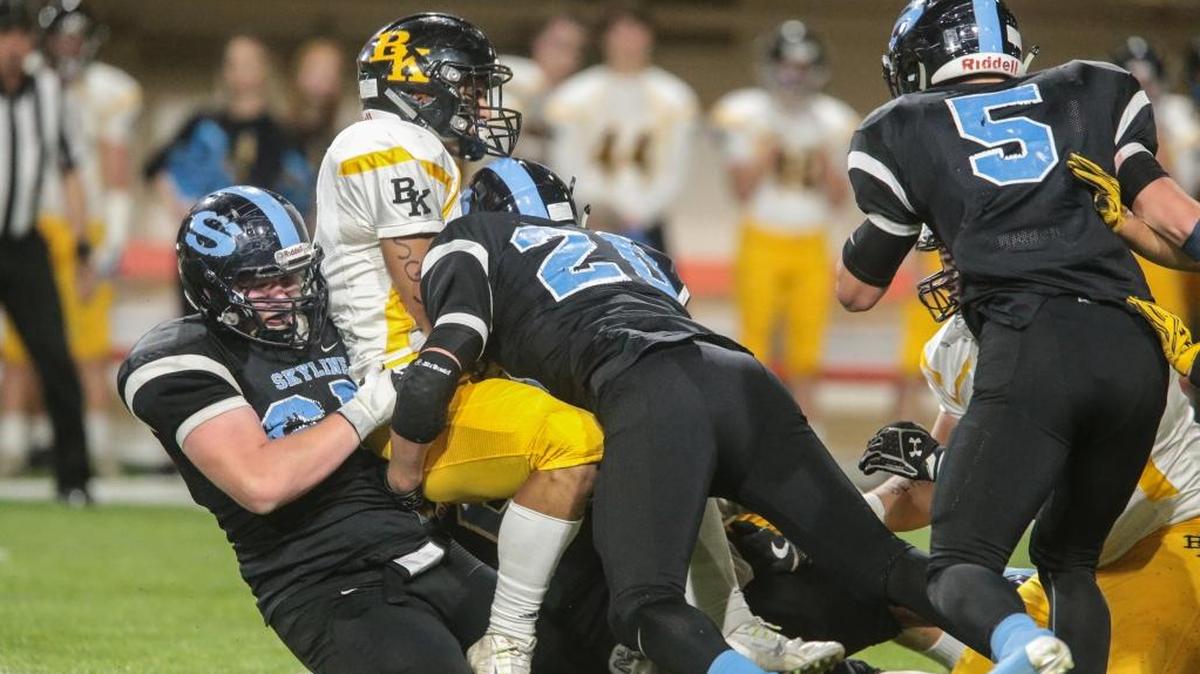 Skyline’s Daniel Webb, left, drags down Bishop Kelly running back Cameron Foley during the 4A state quarterfinals Thursday at Holt Arena in Pocatello. The Grizzlies’ defense held Bishop Kelly to 211 total yards of offense.