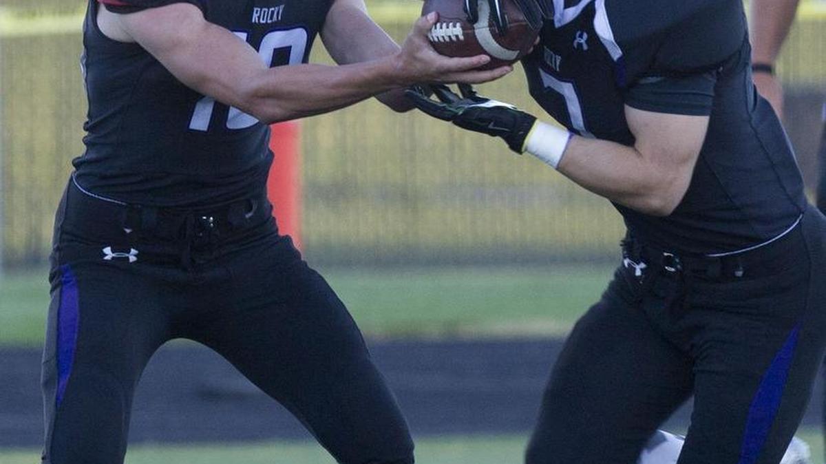 Rocky Mountain quarterback Christian Blaser eyes the defense as he hands the ball off to Jake Roper earlier this season.