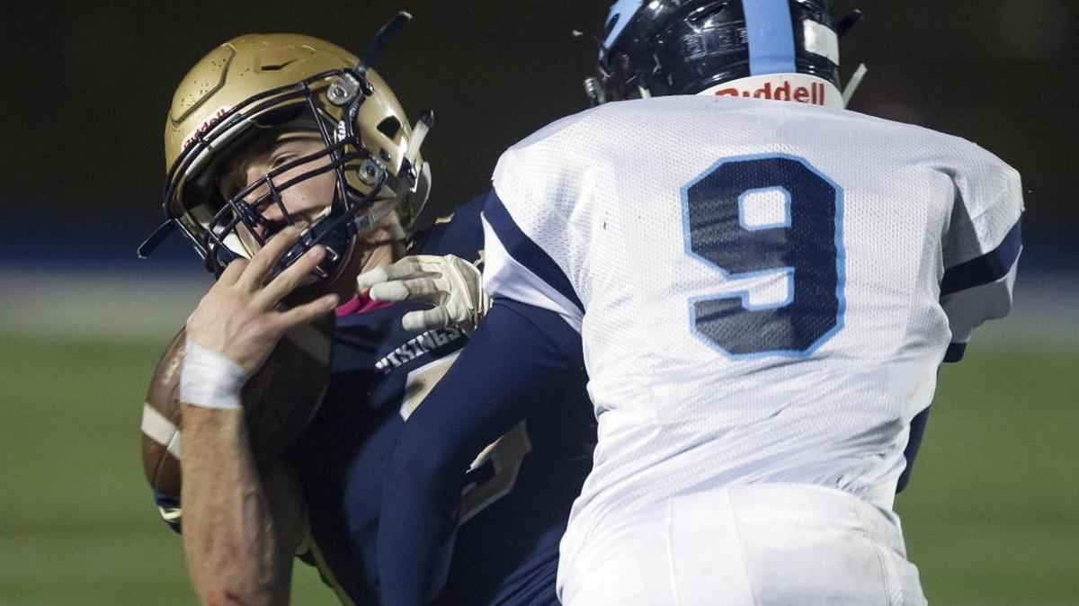 Middleton running back Mitch Beitia takes a hard hit on a tackle by Skyline linebacker Nick Layland in the fourth quarter of their 4A state semifinal.