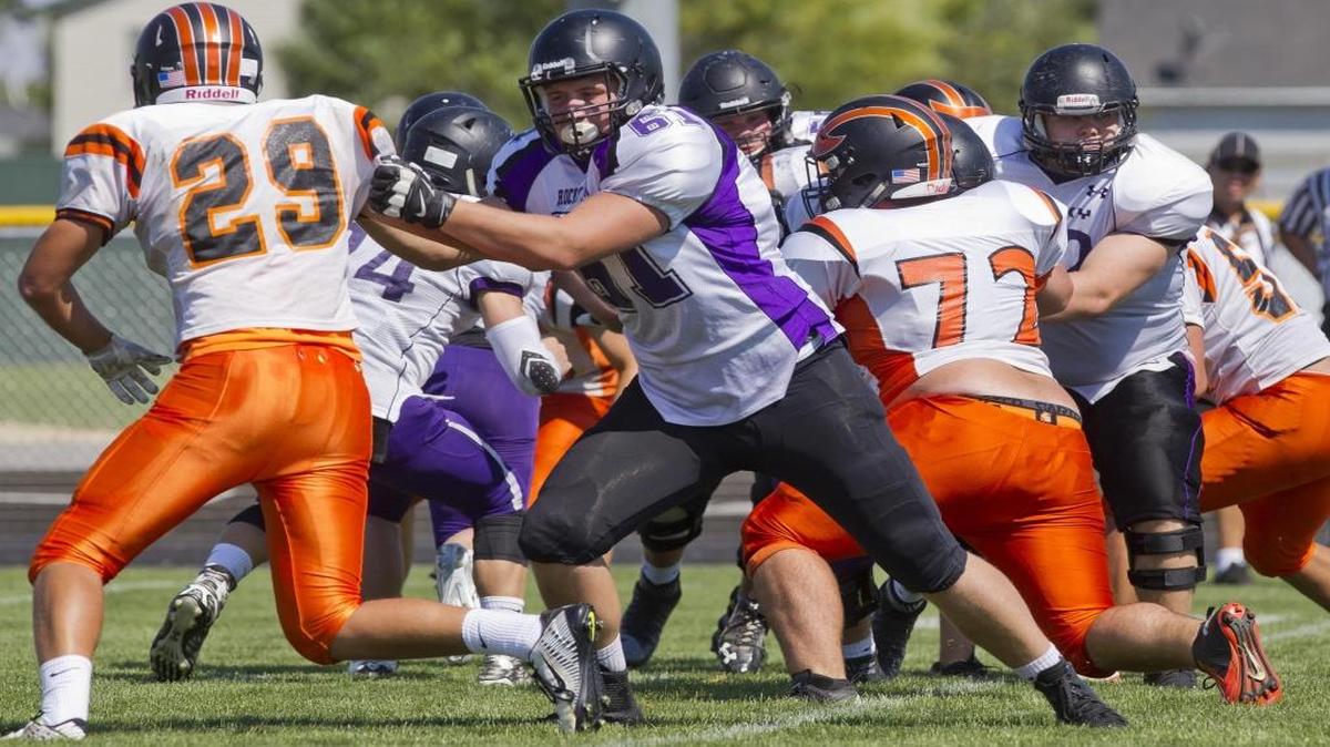 Fruitland’s Trevor Jones tries to get around Rocky Mountain offensive lineman Jake Wilkerson during a jamboree Friday at Vallivue High.