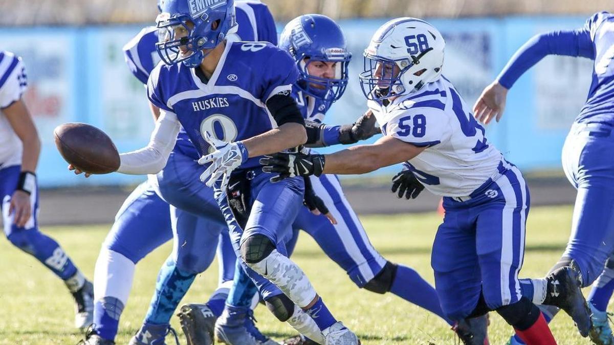 Emmett quarterback Saige Wilkerson avoids a sack by Sugar-Salem’s Zach Belnap in the 3A semifinals Nov. 14.