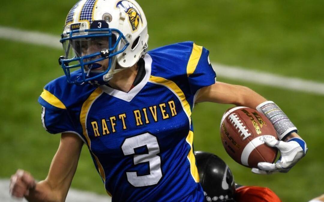 Raft River quarterback Kolten Hitt breaks through a tackle by an Oakley defender Nov. 18 during the 1A Division I state championship at Holt Arena in Pocatello.