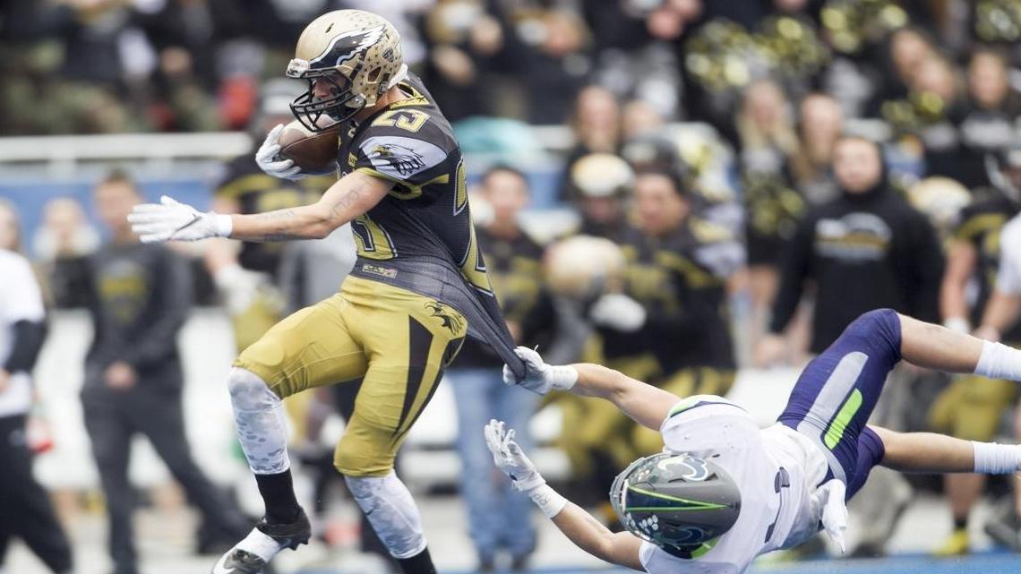 Capital’s Jessie Healy tries to escape the tackle of Mountain View’s Jace Richter during the 5A state championship game at Albertsons Stadium on Nov. 19.