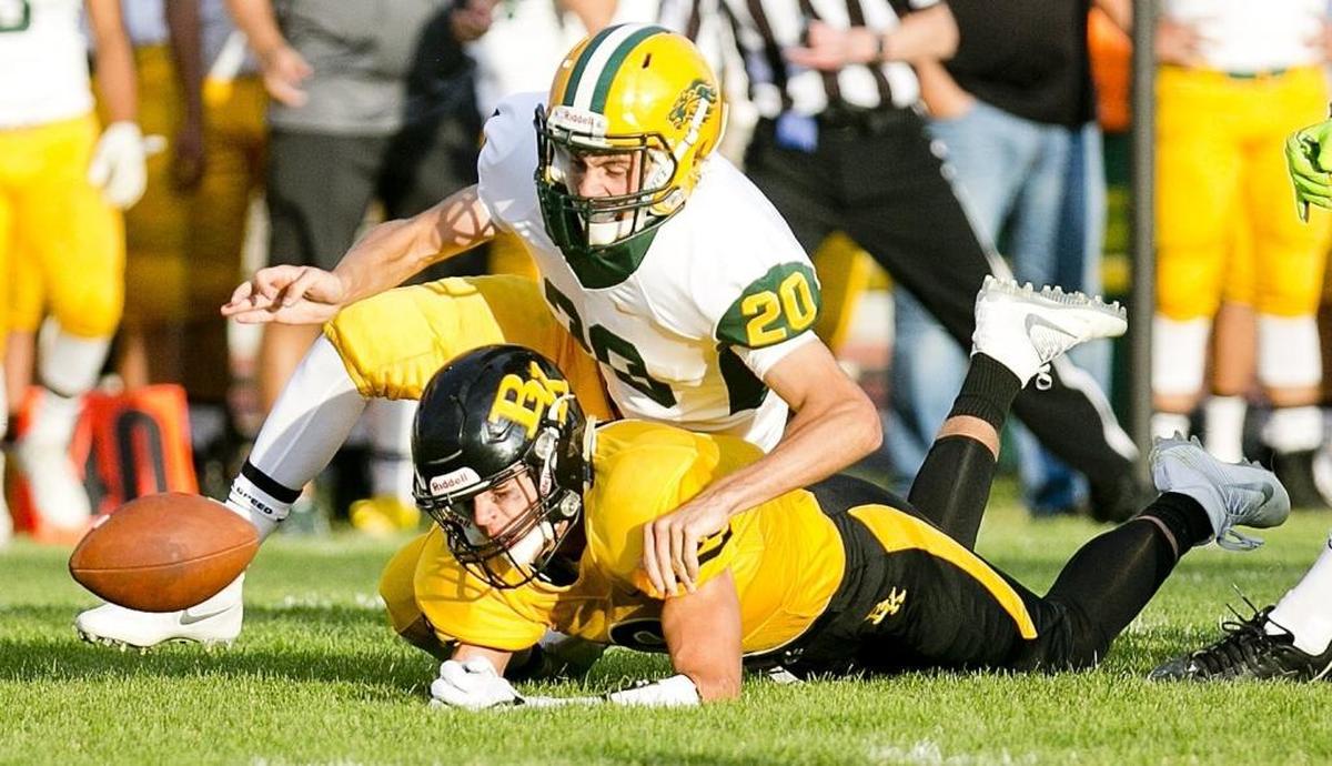 Borah defensive back Chase Nett, top, scrambles for a loose ball last season at Bishop Kelly.