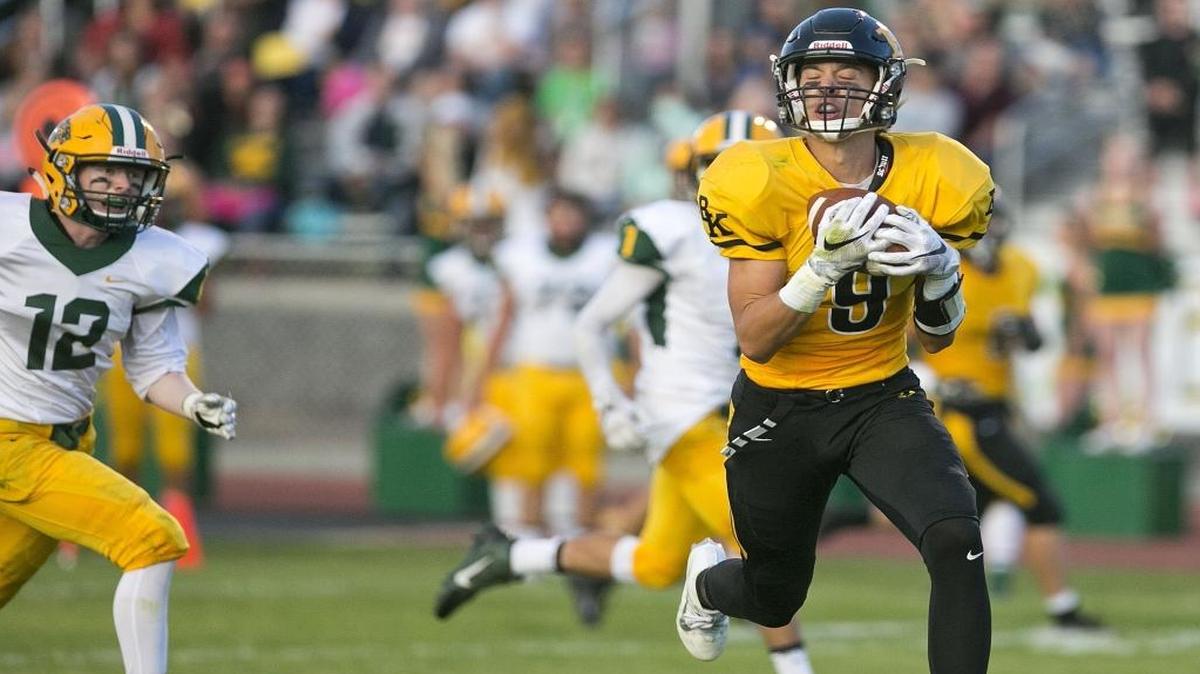 Bishop Kelly’s Vince Sengelmann hauls in a touchdown pass behind Borah’s Cory Lewis on Friday.