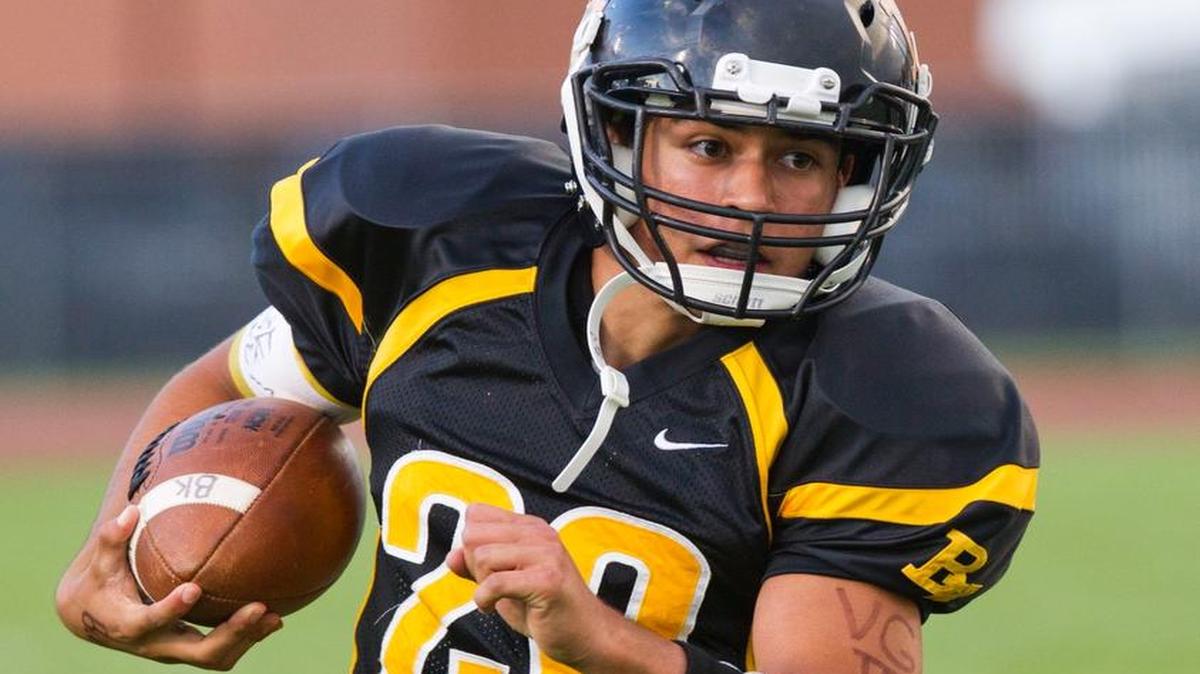 Bishop Kelly’s Luke Burley looks for running room against Vallivue last fall.