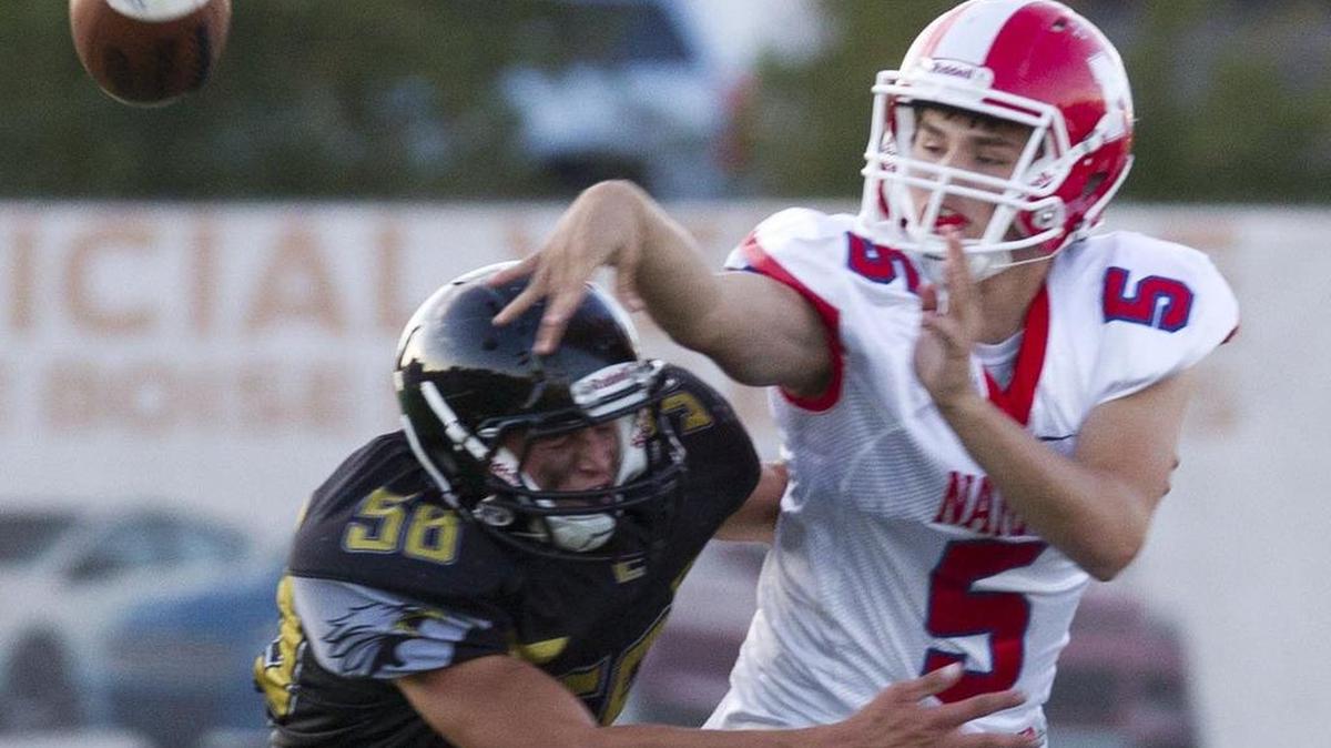 Capital High football players who earn the Gurkha honored wear distinctive black helmets.