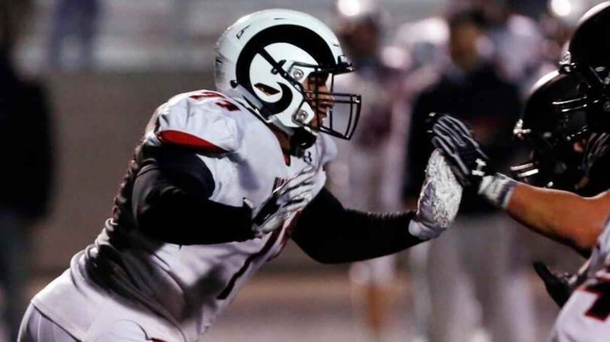 Highland defensive tackle Tommy Togiai breaks upfield during a 5A state semifinal game at Rocky Mountain High.